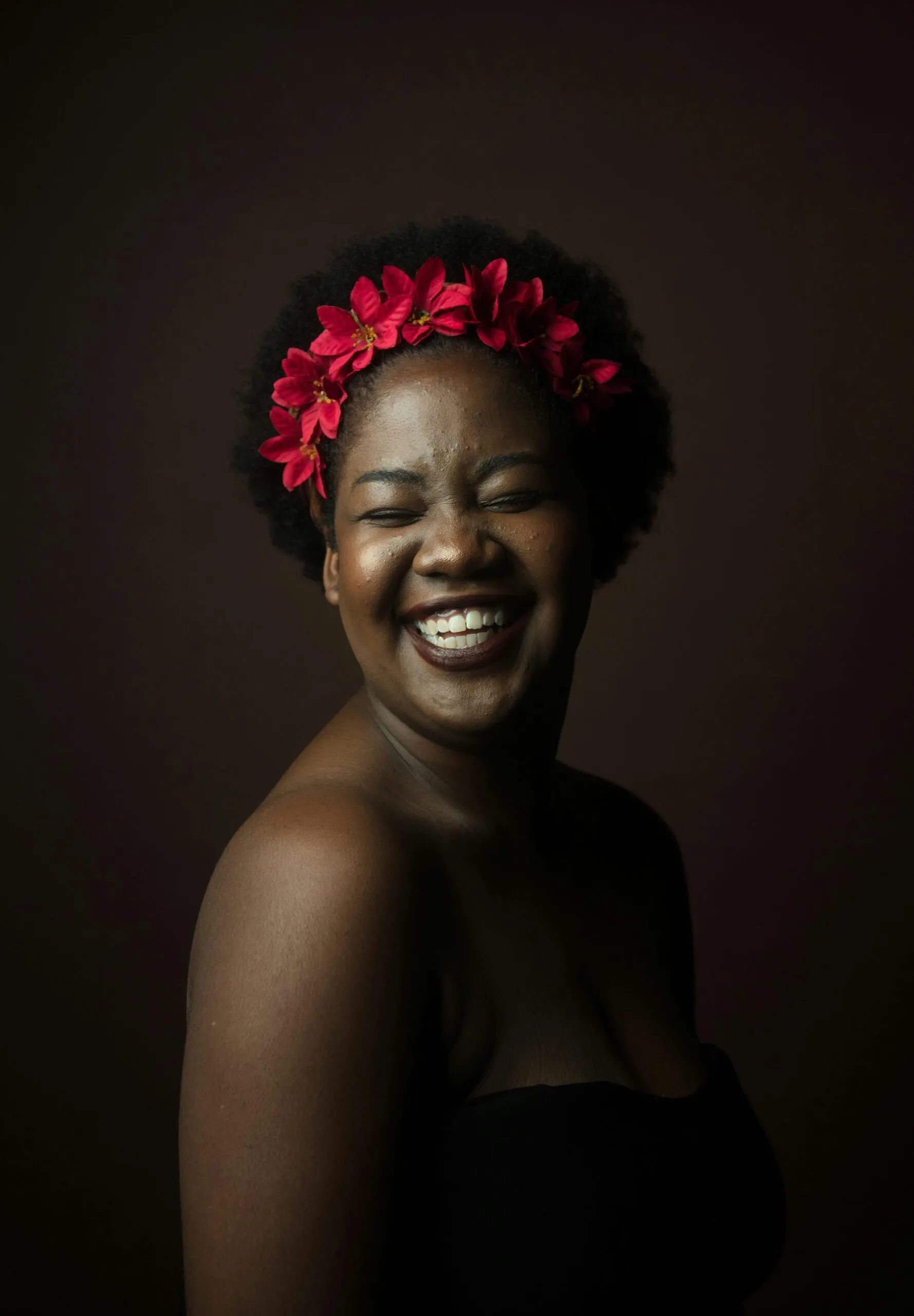 A joyful woman smiling with a flower crown